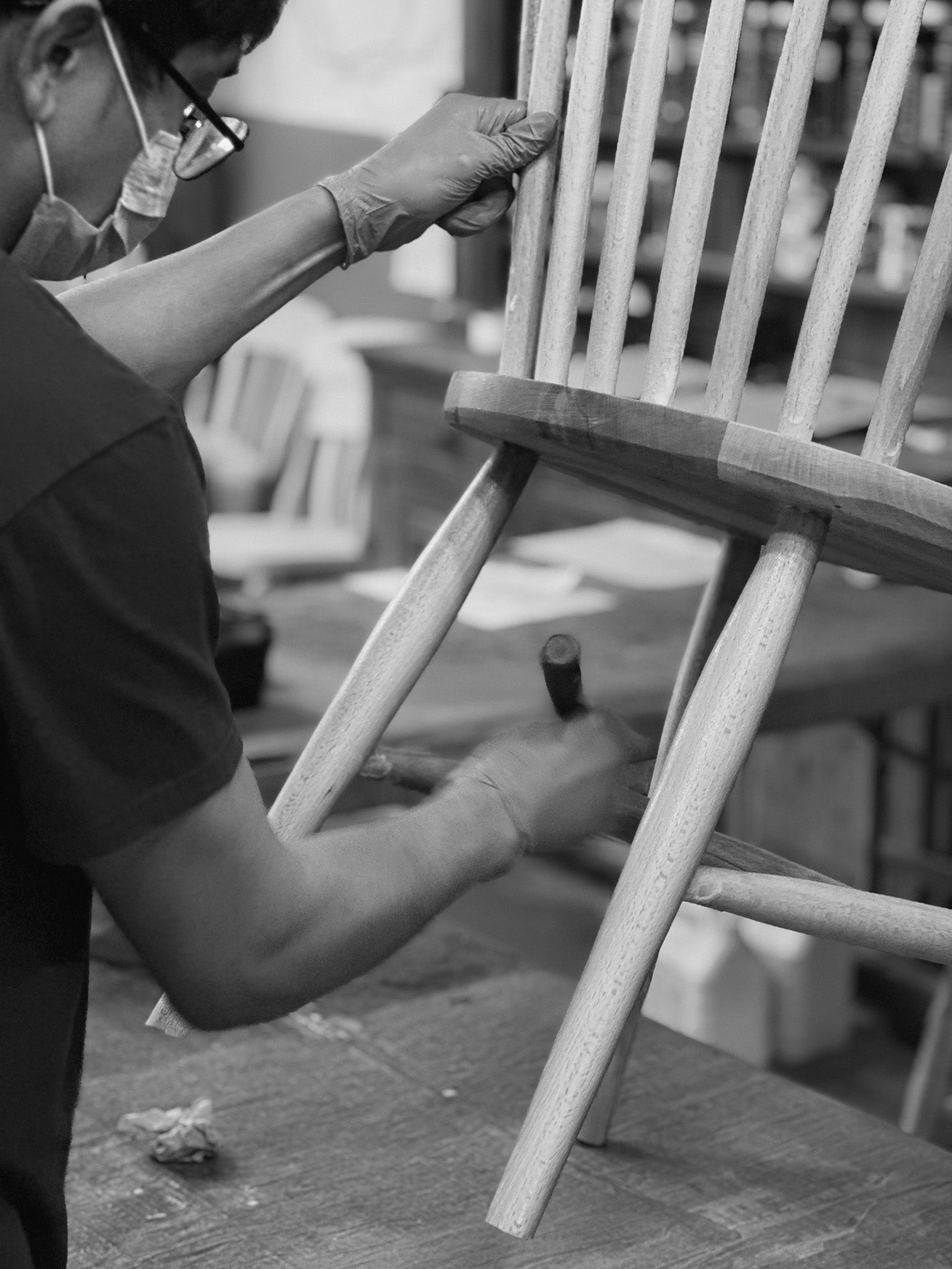 a craftsmen applying the final touches to a scandi dining chair